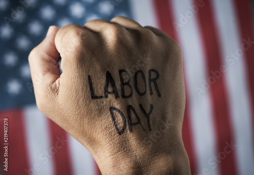 raised fist, american flag and text labor day