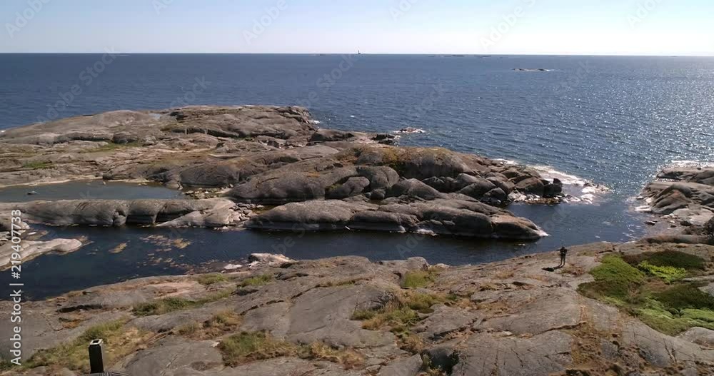 Rocky island, C4K aerial tracking view of a rocky isle klovarskar, on a sunny summer day, in saaristomeri national park, Varsinais-suomi, Finland