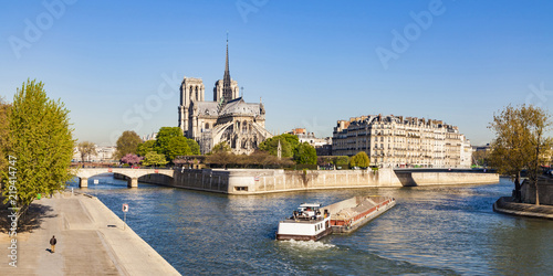 France, Paris, Notre Dame Cathedral and fright ship on Seine river