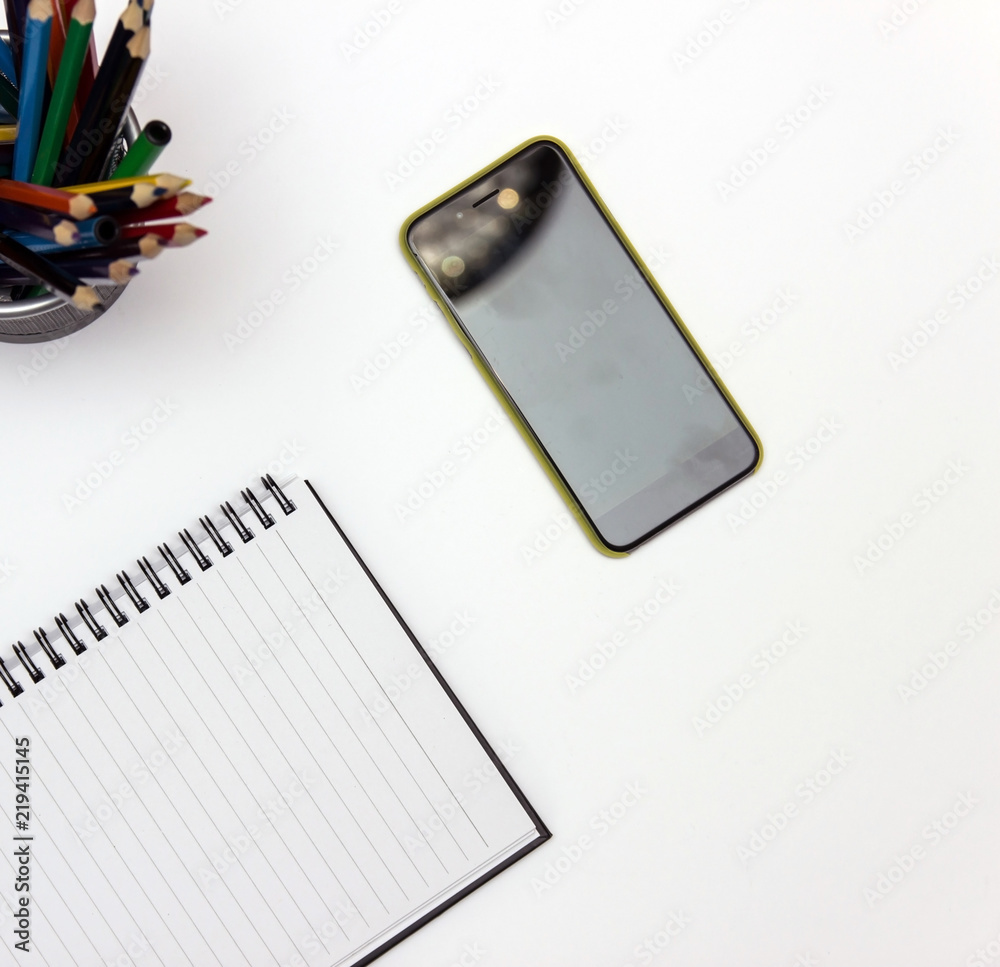 Pencils, notebook, mobile phone.