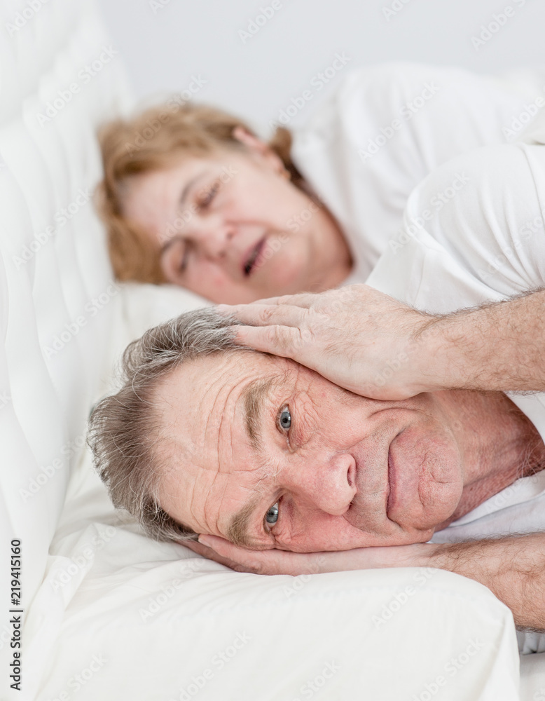 senior man who can not sleep because his wife snores senior man who can not sleep because his wife snores
