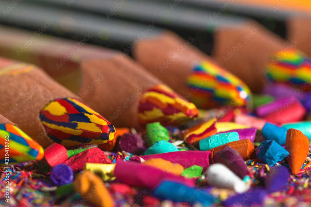 Obraz premium Colourful pencils row with pencil graphite and shavings. Back to school background. Macro photography.