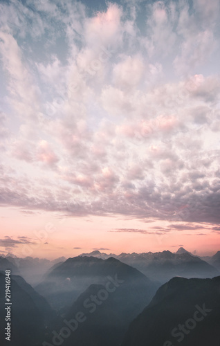 Sunset sky clouds over mountains range peaks Landscape Travel destinations wild nature scenic aerial view .