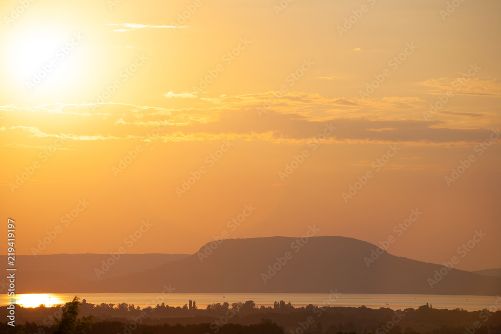 Obraz premium Sunset at lake Balaton with the Badacsony mountain in Hungary