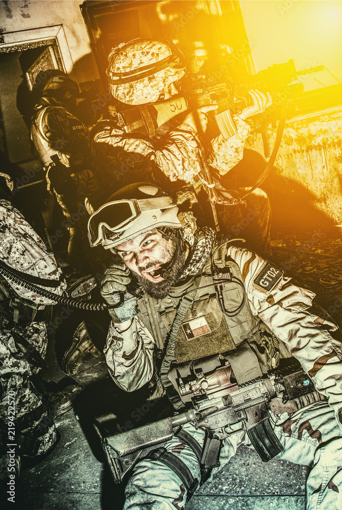 Commando team leader, counter terrorist squad officer, military operator  screaming in radio handset while calling for reinforcements, evacuation or  artillery support during intensive night firefight Stock Photo | Adobe Stock