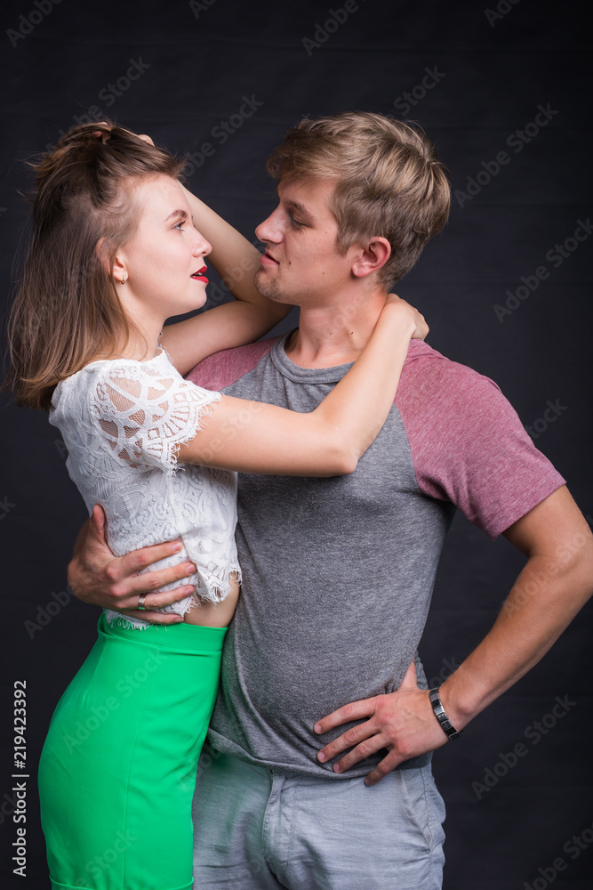 Lovers kissing each other on black background Lovers kissing each other on black background