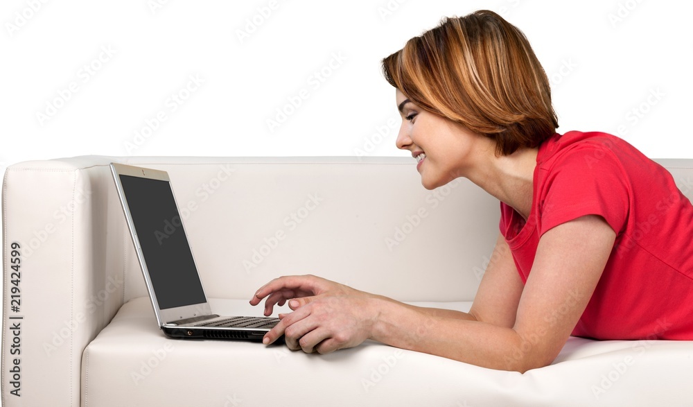 Portrait of a Woman Using her Laptop on a Couch Portrait of a Woman Using her Laptop on a Couch