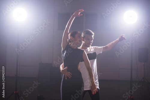 Young couple dancing social danse kizomba or bachata or semba or taraxia in dancing class background photo