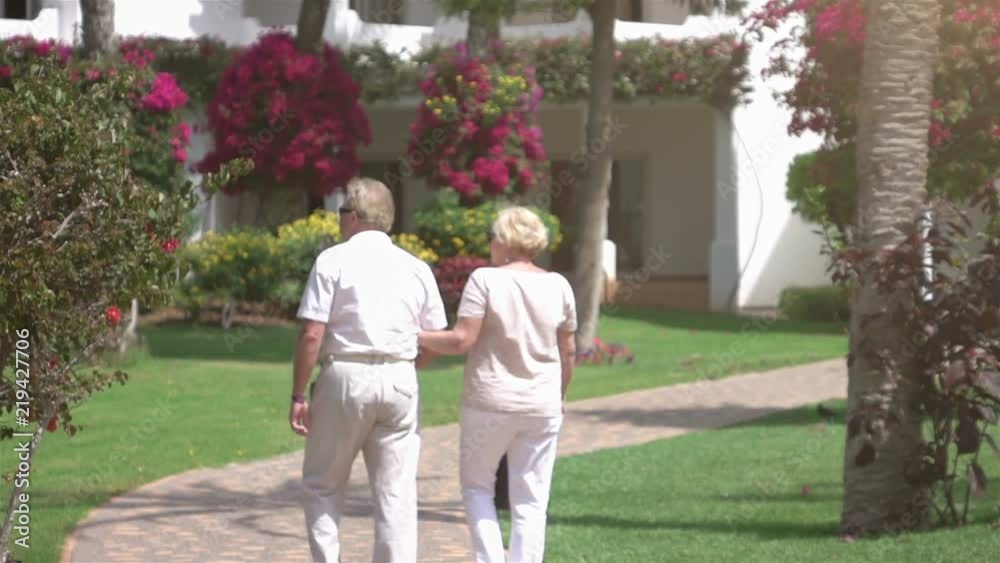Senior couple walking in the garden in slow motion 250fps Senior couple walking in the garden in slow motion 250fps