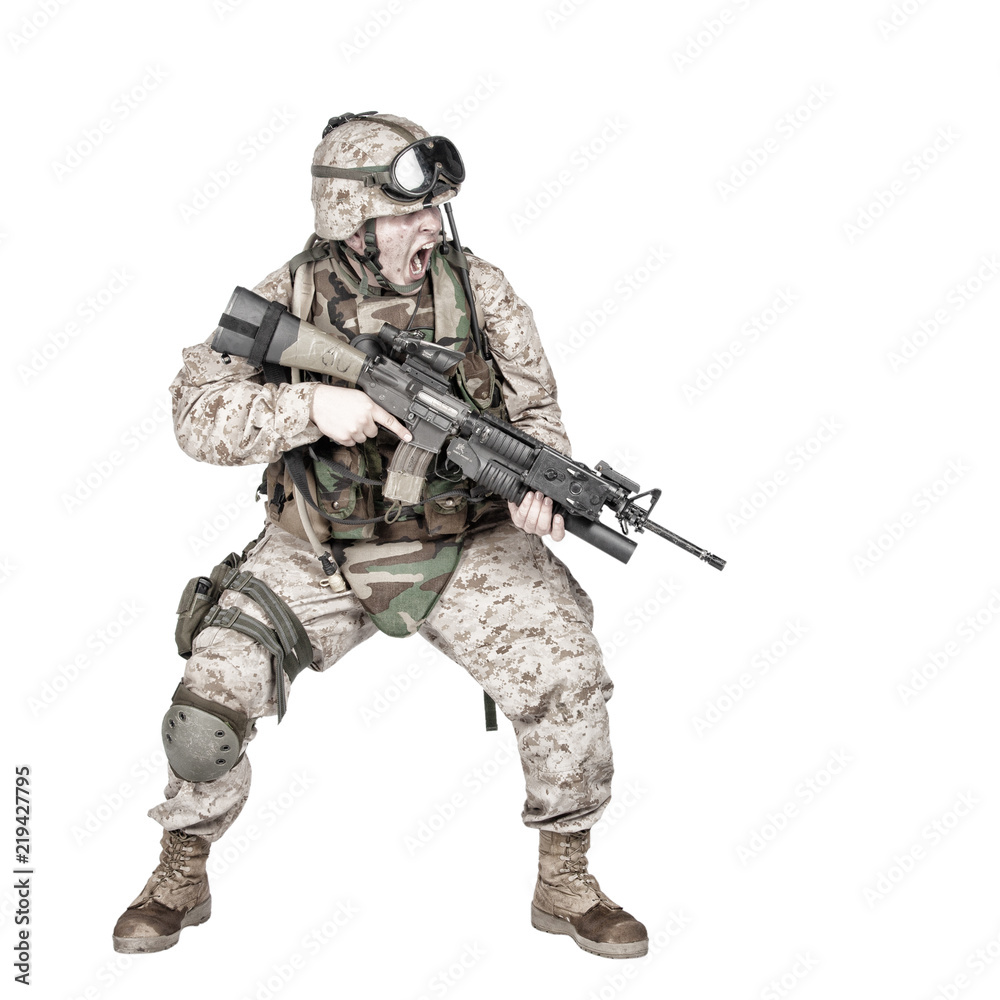 Studio shoot of modern infantry soldier, U.S. marine rifleman in combat uniform, helmet and body armor, screaming and crouching down with assault service rifle in hands isolated on white background Studio shoot of modern infantry soldier, U.S. marine rifleman in combat uniform, helmet and body armor, screaming and crouching down with assault service rifle in hands isolated on white background