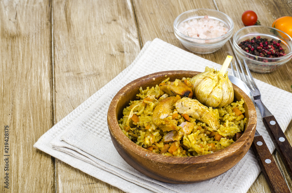 Rice with chicken meat and garlic in wooden bowl Rice with chicken meat and garlic in wooden bowl