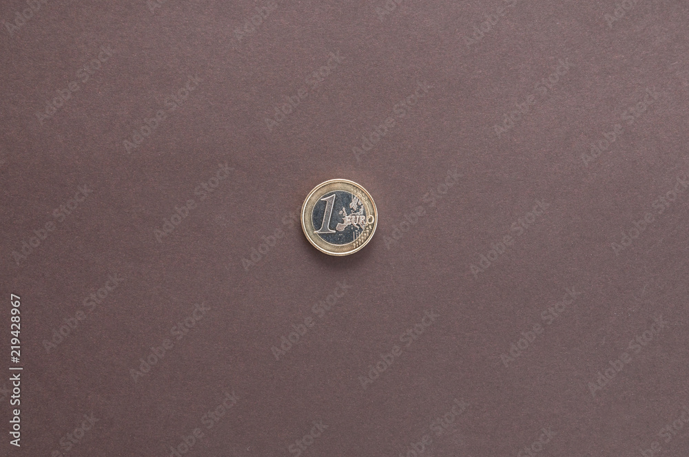 one Euro coin on dark background top view one Euro coin on dark background top view
