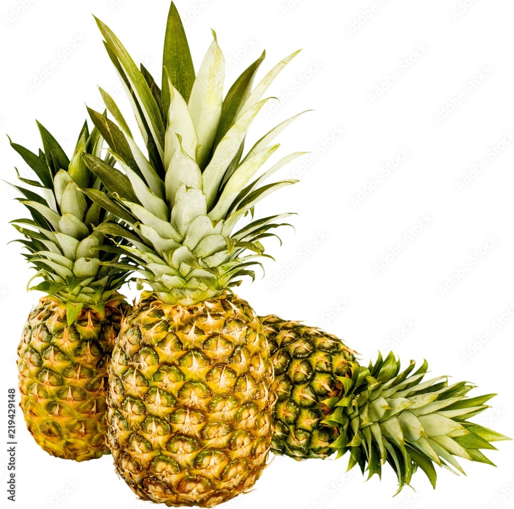 Fototapeta premium Ripe tropical pineapples on white background