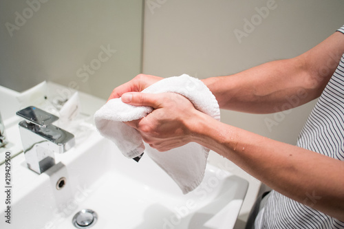 man washing his hands through running water