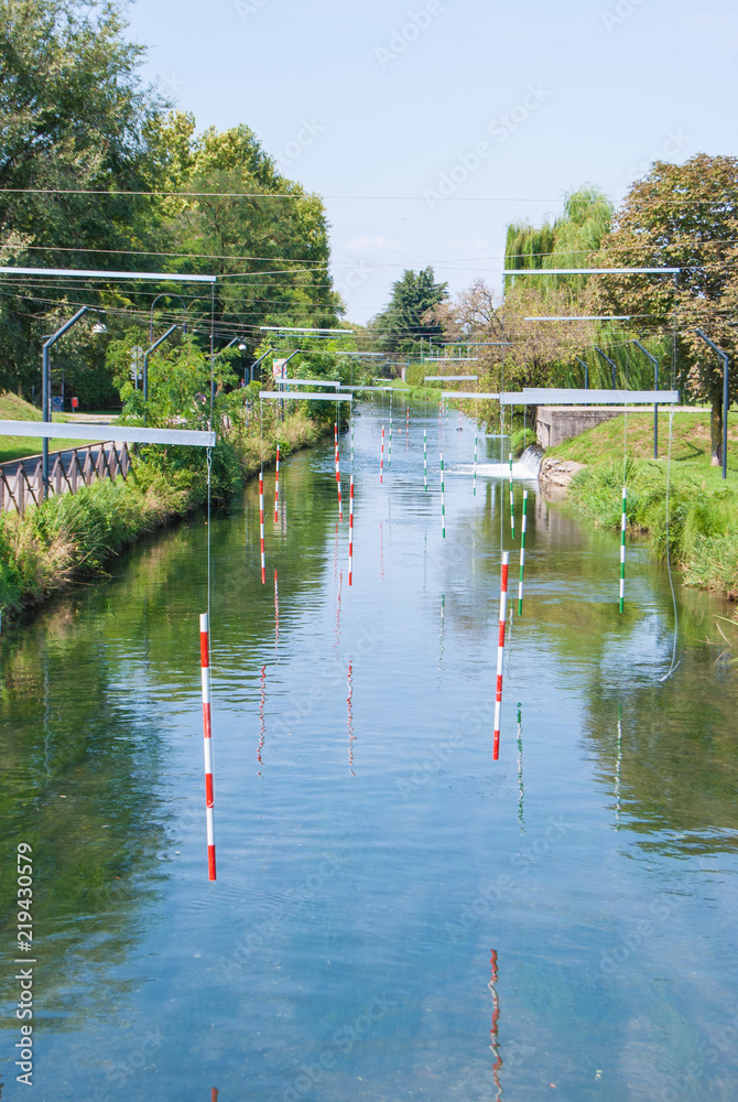 Bicolored stakes of route for canoe on the river