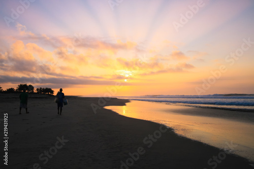 Mexican Fishermen Walking on Pacific Ocean Beach at Sunrise. © Angelina Cecchetto