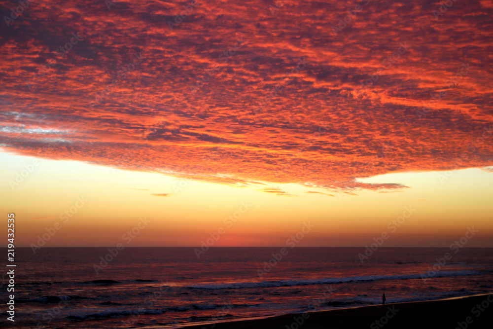 Dramatic Volcanic Crimson Sunset over Pacific Ocean