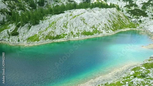 Aerial: Triglav national park in Slovenia, Seven lakes valley. Flying at Ledvica lake. Beautiful valley with lakes between high mountains.