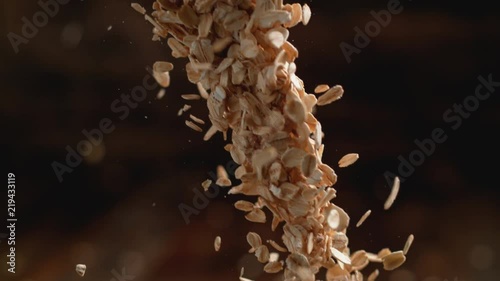 Camera follows throwing oats over a pile of oats. Shot with high speed camera, phantom flex 4K. Slow Motion.
