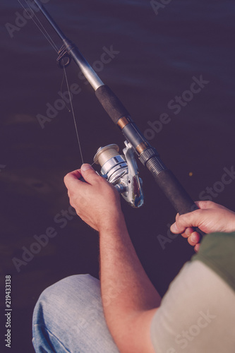 Man fisherman catches a fish. Fishing, spinning reel, fish.