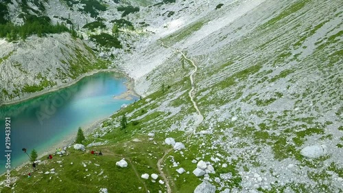 Aerial: Triglav national park in Slovenia, Seven lakes valley. Flying at Ledvica lake. Beautiful valley with lakes between high mountains.