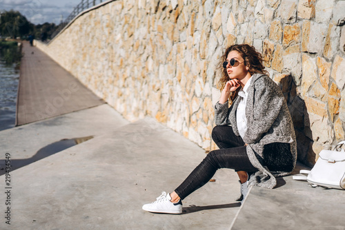 Cute girl with curly hair relaxing outdoor