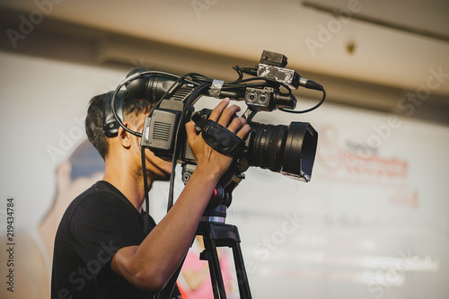 professional cameraman - covering on event with a video