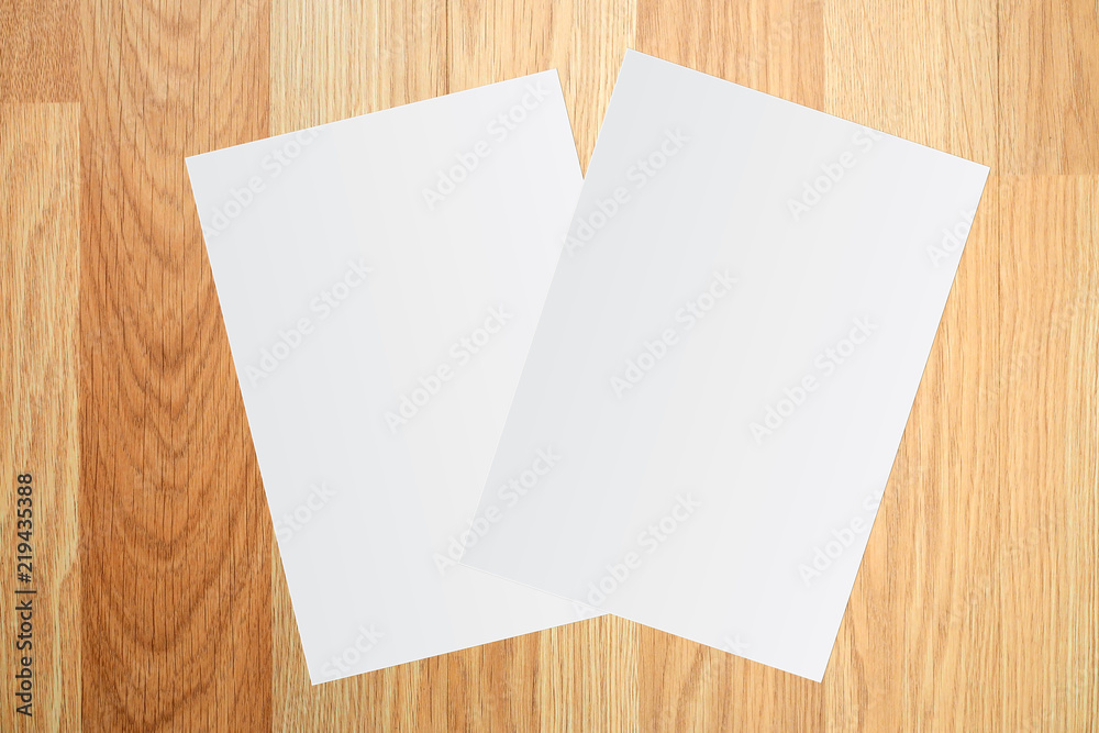 White paper and space for text on brown wooden background White paper and space for text on brown wooden background