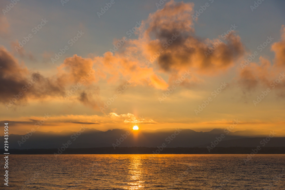 Golden Sunrise behind Alps Mountains and over Lake Leman.