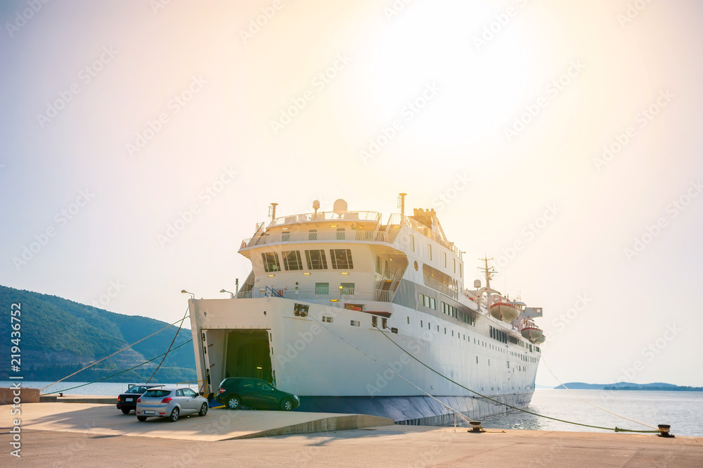 ferry standing on the dock waiting for loading, during the bright sunset