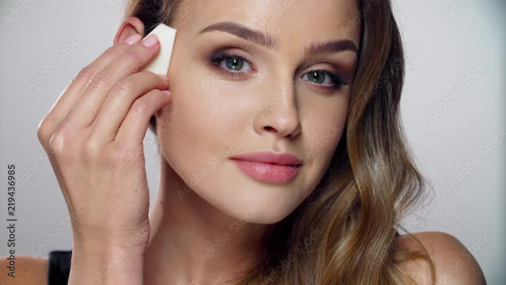 Beauty Makeup. Woman Applying Face Cosmetic With Sponge Beauty Makeup. Woman Applying Face Cosmetic With Sponge
