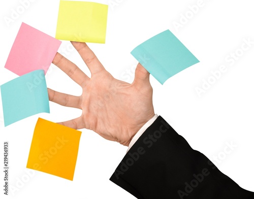 Close-up of businessman hand with colored stickers isolated on