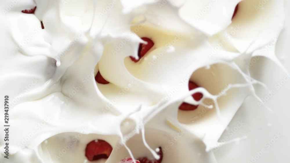 Camera follows tossing raspberries in yogurt. Overhead shot. Shot with high speed camera, phantom flex 4K. Slow Motion. Camera follows tossing raspberries in yogurt. Overhead shot. Shot with high speed camera, phantom flex 4K. Slow Motion.