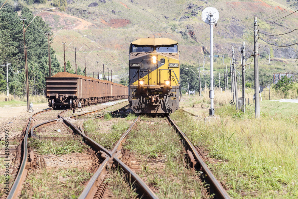 Perspective view of train wagons of iron ore and rails, industry.