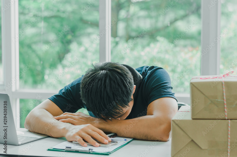 The postman is asleep while preparing a mailbox to send to the recipient. Delivery concept The postman is asleep while preparing a mailbox to send to the recipient. Delivery concept