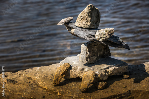 Inukshuk by the river edge. photo