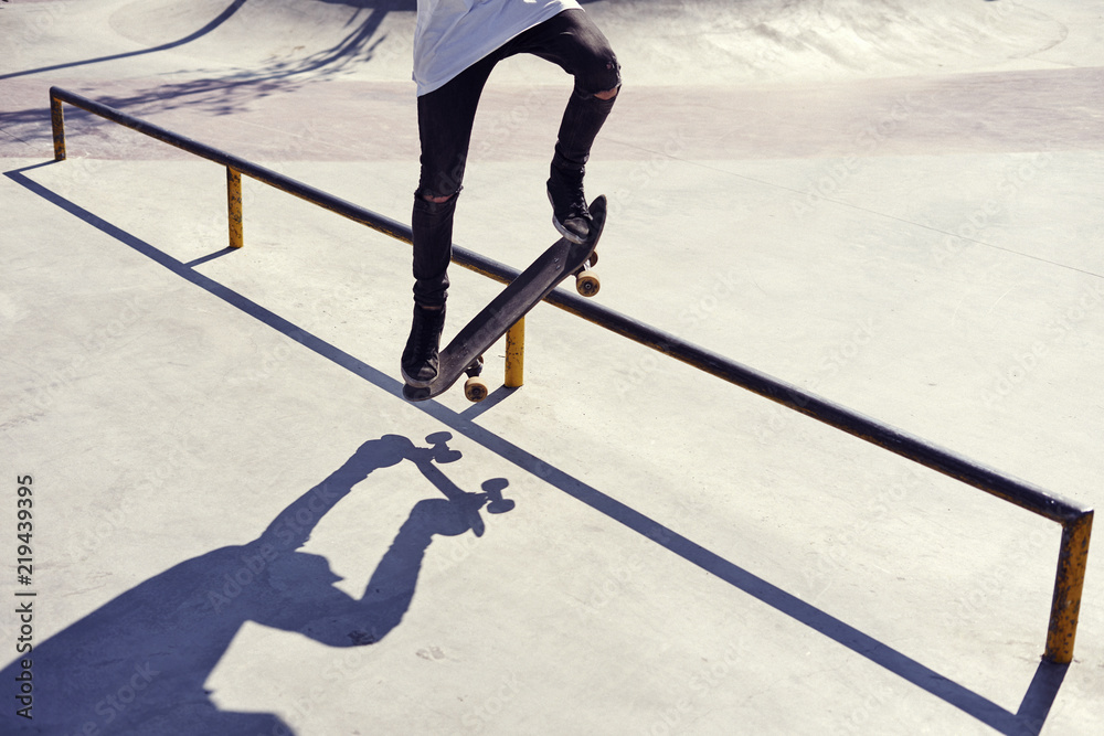 Naklejka premium Skateboarder doing a trick in a skate park, practice freestyle extreme sport
