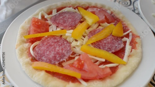 Children make a pizza with his own hands in the restaurant photo