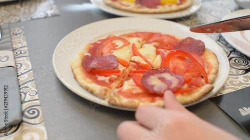 Children make a pizza with his own hands in the restaurant photo