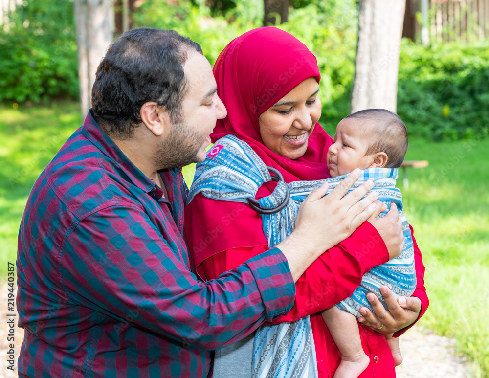 Fototapeta premium An Arabic couple is talking to their crying baby
