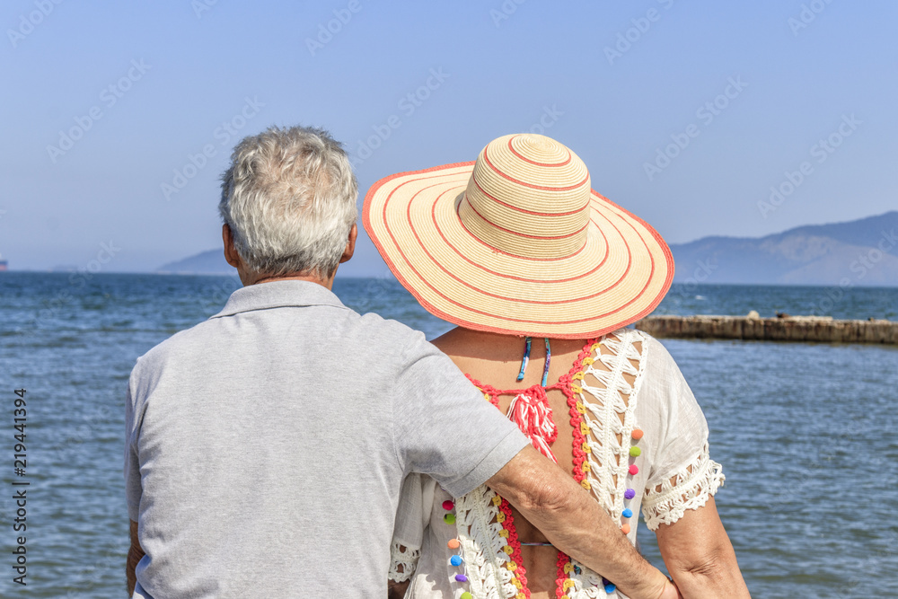 Senior couple relaxing and contemplating the sea