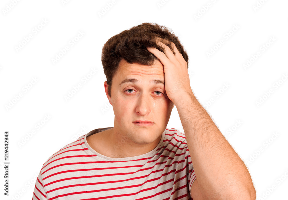 portrait of a crying man holding his head in despair. emotional man isolated on white background portrait of a crying man holding his head in despair. emotional man isolated on white background