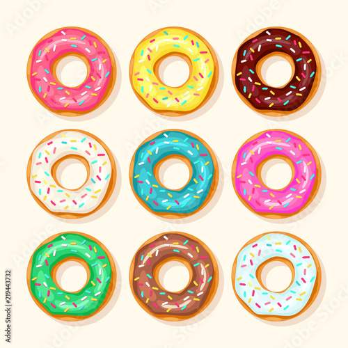 Pink donut, chocolate donut, lemon and blue mint donuts with different topping on white background
