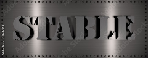Brushed steel plate with rivets around it and the word 