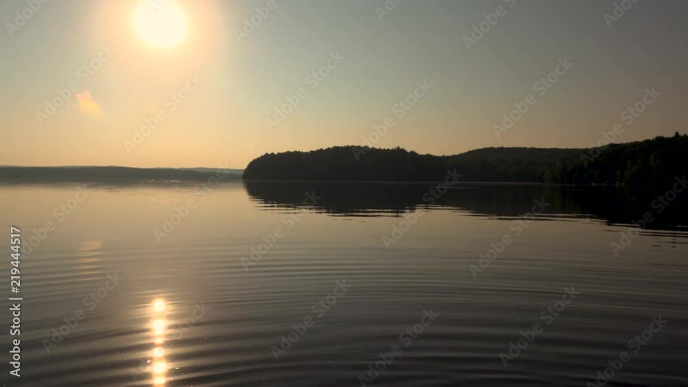 Sunrise over beautiful lake as water ripples Sunrise over beautiful lake as water ripples