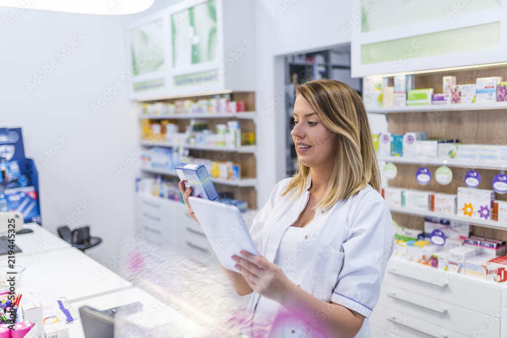 Modern pharmacist with digital tablet searching for products in database. Modern healthcare system. Medical and pharmaceutical Modern pharmacist with digital tablet searching for products in database. Modern healthcare system. Medical and pharmaceutical
