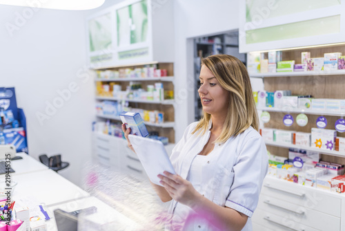 Modern pharmacist with digital tablet searching for products in database. Modern healthcare system. Medical and pharmaceutical