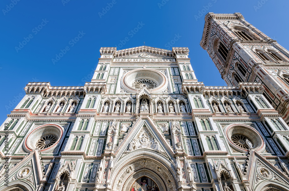 Facade of the famous basilica of Santa Maria del Fiore (Saint Mary of the flower), cathedral of Florence, Italy, with the bell tower of Giotto