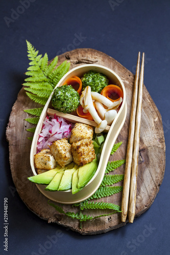 Japanese bento box lunch withg mushrooms, onigiri and tofu photo