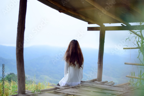 Young lonely woman sitting in cottage and looking view of nature, Relaxation on vacation trip